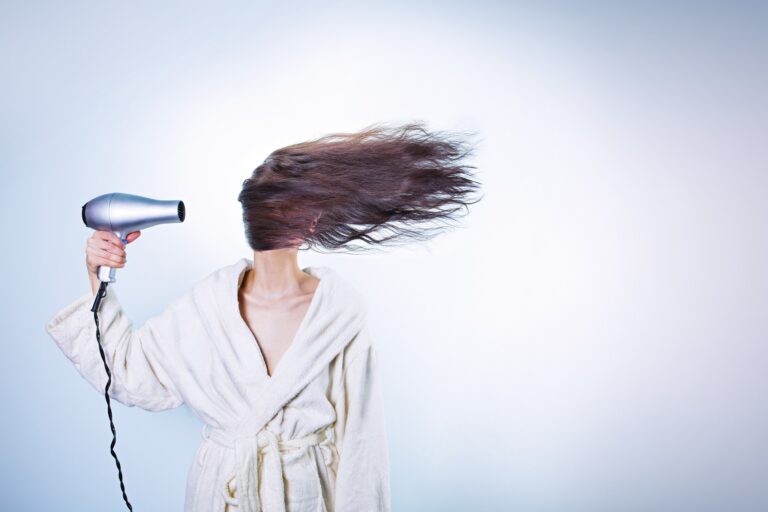 Woman with a blowdryer trying hard to look pretty